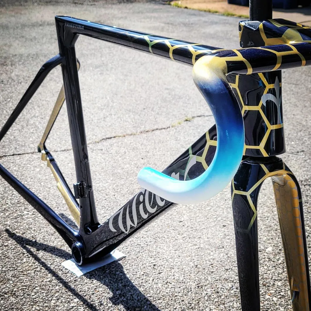 Bike paint designs: gold honeycomb pattern over black on a Wilier Triestina road frame with blue to white faded bars