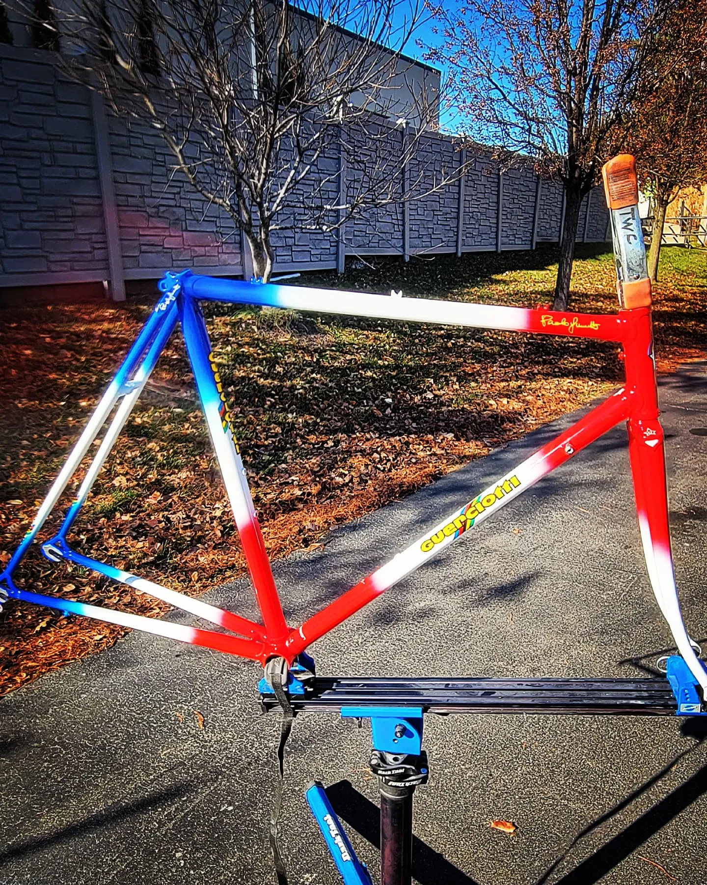 Custom bicycle painting: steel Guerciotti road frame with a blue, white and red fade and yellow script logo