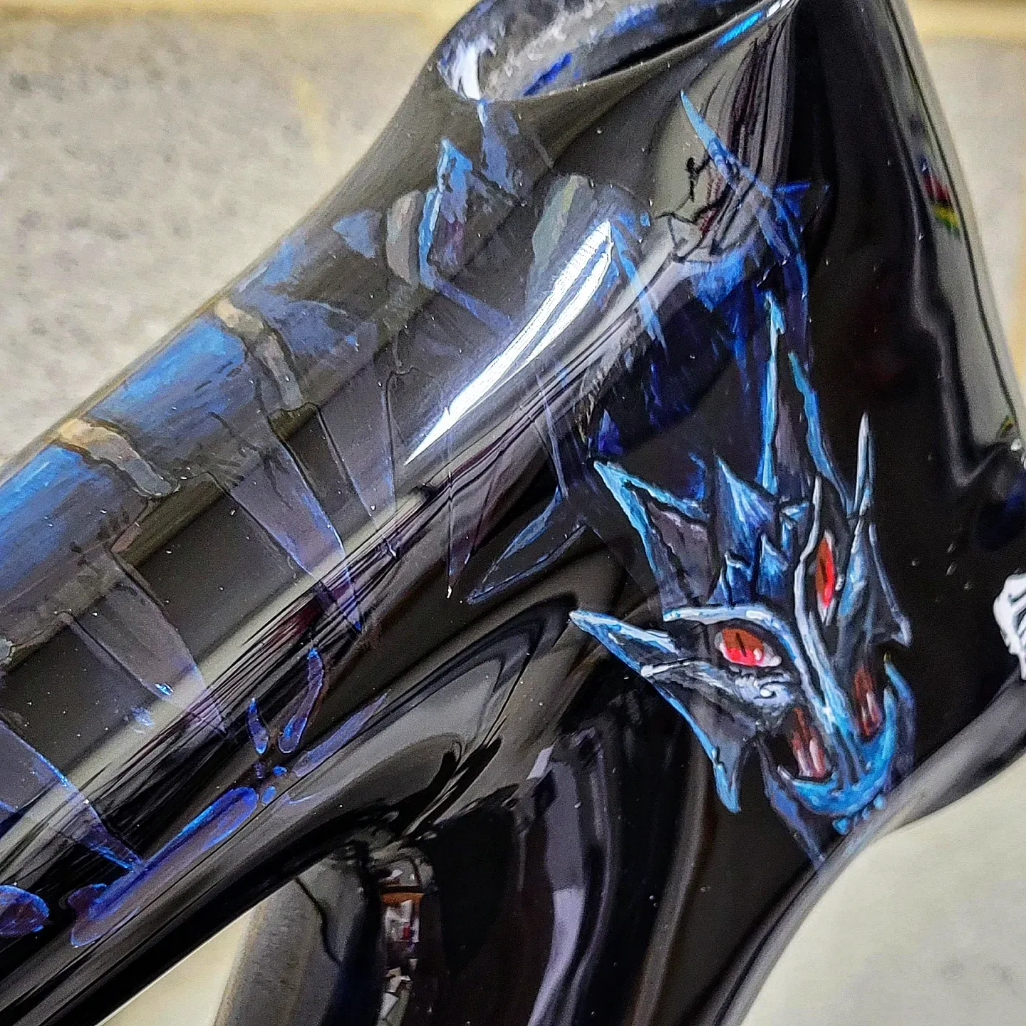 Custom bike paint design: hand-painted blue dragon with red eyes on a black metallic Specialized Chisel frame